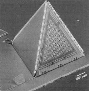 A microscopic view of a tiny microphone on a computer chip being developed by researchers at Lucent Technologies's Bell Laboratories in Murray Hill, New Jersey. The tiny pyramid-shaped microphone could lead to radio communicators the size of a wristwatch. Reproduced by permission of AP/Wide World Photos.