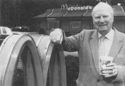 Richard "Dick" McDonald stands in front of a McDonald's restaurant in Manchester, New Hampshire. He and his brother Maurice pioneered the quick-service restaurant that evolved into McDonald's. Reproduced by permission of AP/Wide World Photos.