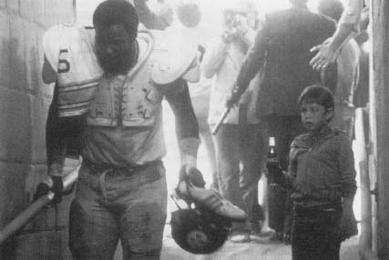 Football player "Mean" Joe Green appearing in a now-famous Coca-Cola telvision commercial. Reproduced by permission of AP/Wide World Photos.