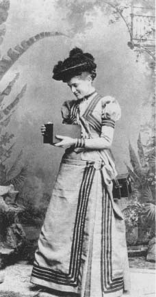 Kitty Kramer, the first Kodak Girl, shown using a Kodak camera in 1890. Reproduced by permission of AP/Wide World Photos.