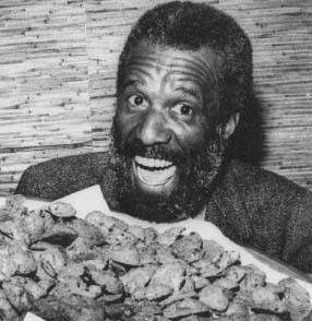 Wally Amos holding a tray of his famous cookies. Reproduced by permission of AP/Wide World Photos.