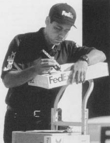 FedEx makes about 4.8 million shipments each business day, keeping their 200,000 employees constantly on the move. Reproduced by permission of AP/Wide World Photos.