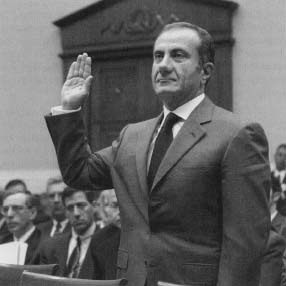 Jacques Nasser, former president and CEO of Ford Motor Company, raises his hand to be sworn in at the start of a House Commerce Committee hearing in June 2001. The committee was looking into Ford's recall of vehicles outfitted with Firstone tires after reports of multiple tire blow-outs on Ford Explorers. Reproduced by permission of AP/Wide World Photos.